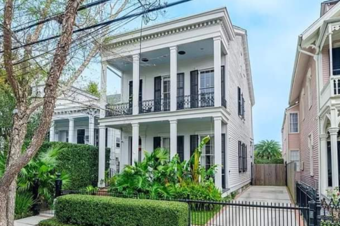 a statue in front of Garden District